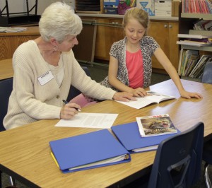 Resident volunteer reading to student at Two Rock Elementary School